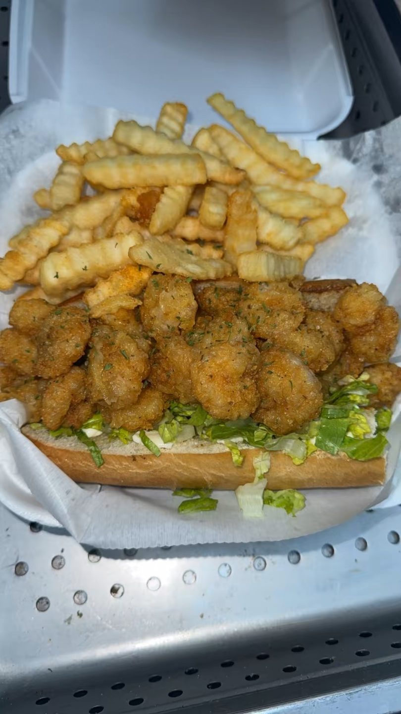 A Lot A Lot Chuckwagon LLC's fried shrimp po'boy with lettuce and crinkle-cut fries.